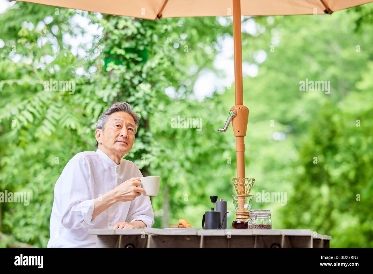 Senior man drinking coffee on the terrace Stock Photo