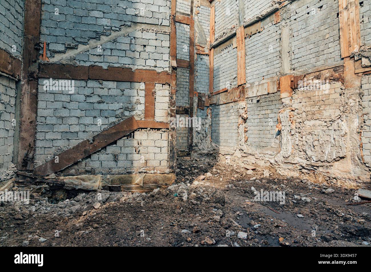 Abandoned building structure with ruined interior brick walls and ...