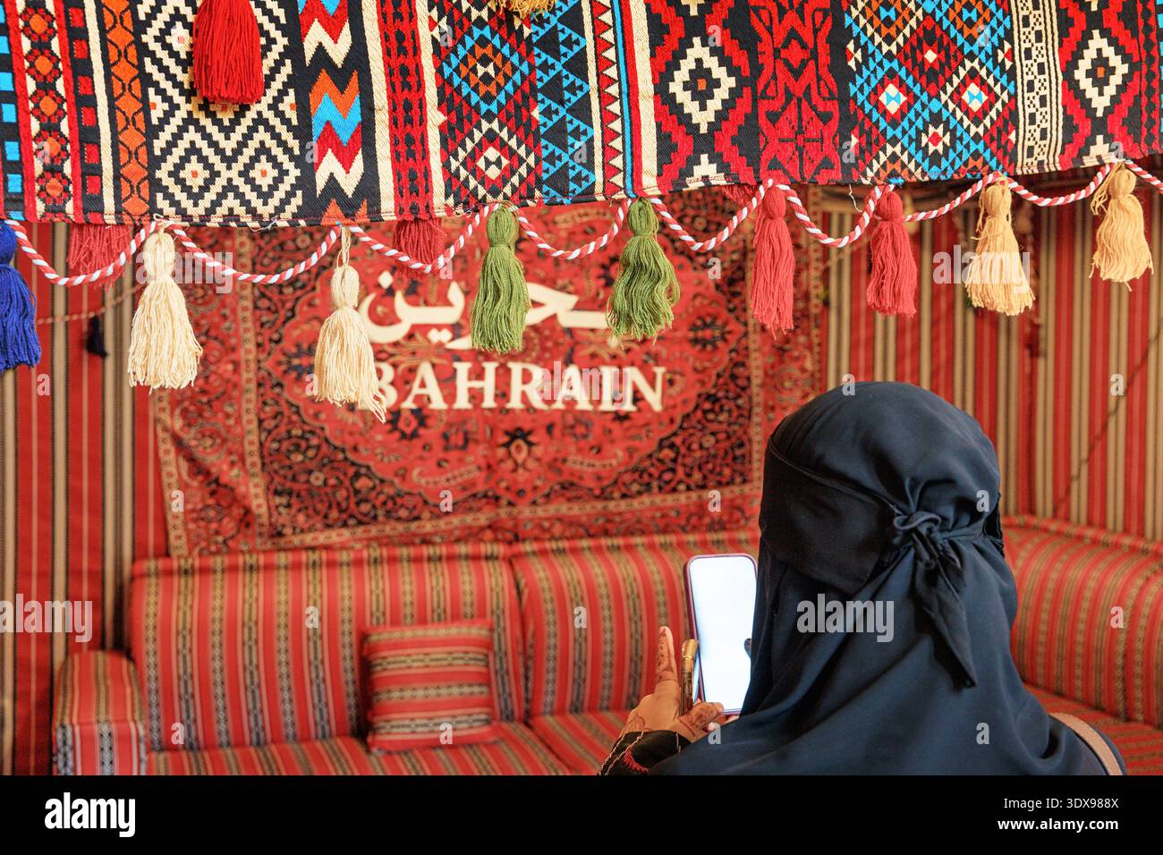 Bahrain Patterns Woman taking a picture of fabric hi-res stock photography and images ...