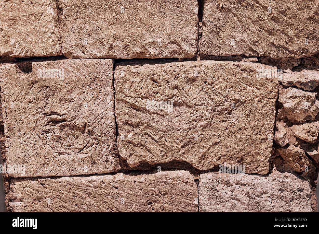 Rough stone wall surface showing ancient masonry texture for architectural backgrounds, strong construction, and solid foundations Stock Photo