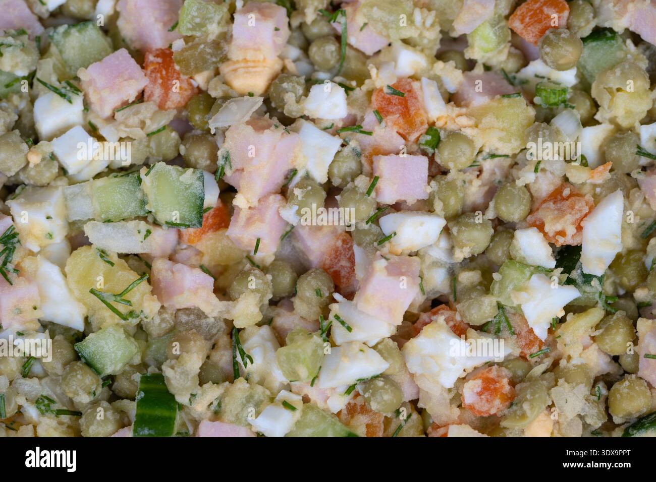 Refreshing grilled meal accompaniment with olives. Chilled olive salad featuring smooth sauce and crunchy peas and cucumbers as perfect grill compleme Stock Photo