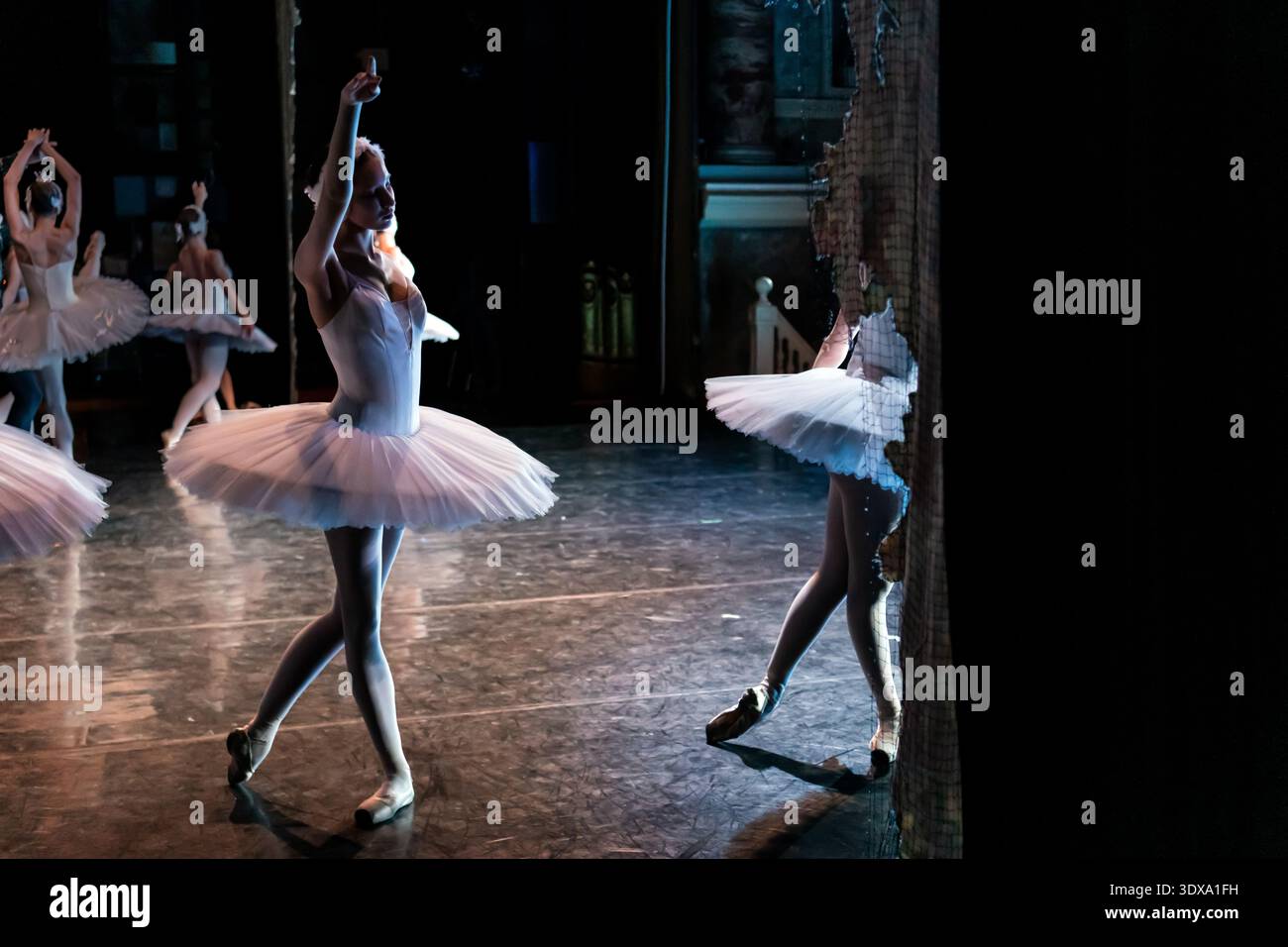 Classical ballet dancer in white tutu performing on stage Stock Photo