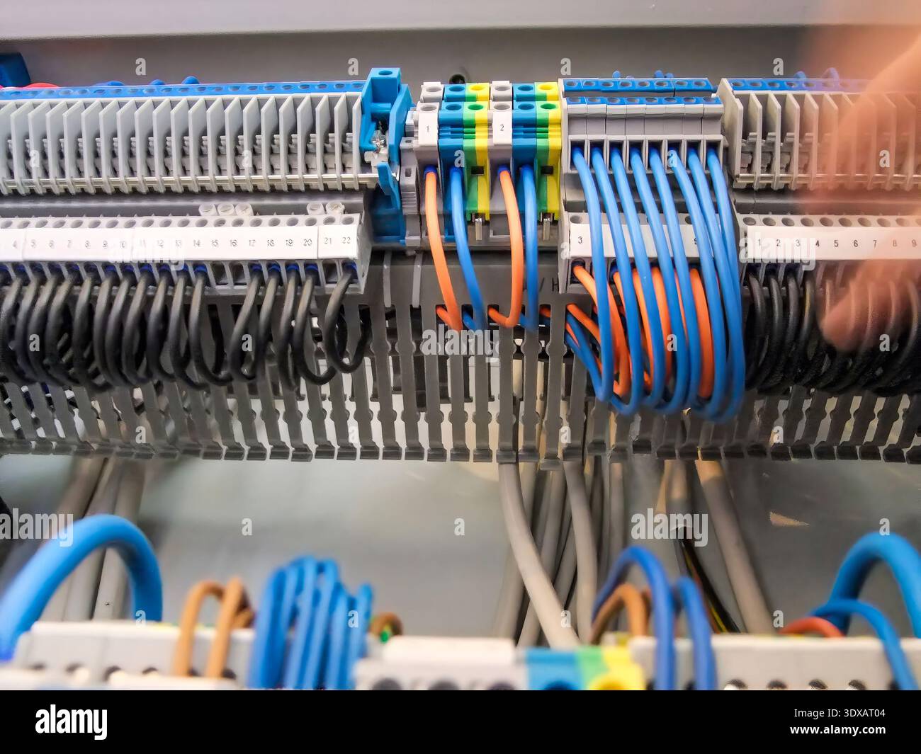Wiring of an electrical panel shows an organized array of black, blue ...