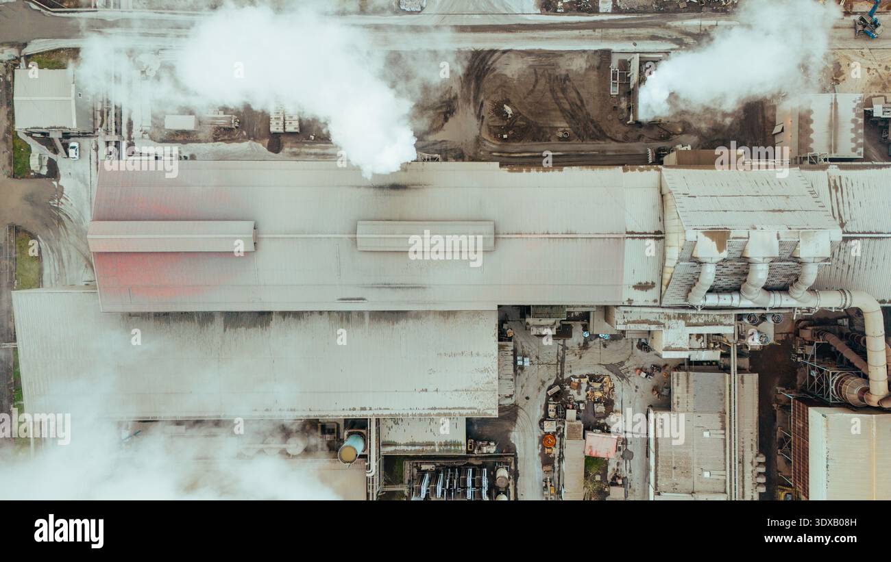 Aerial view of plumes of white smoke rise from industrial chimneys ...