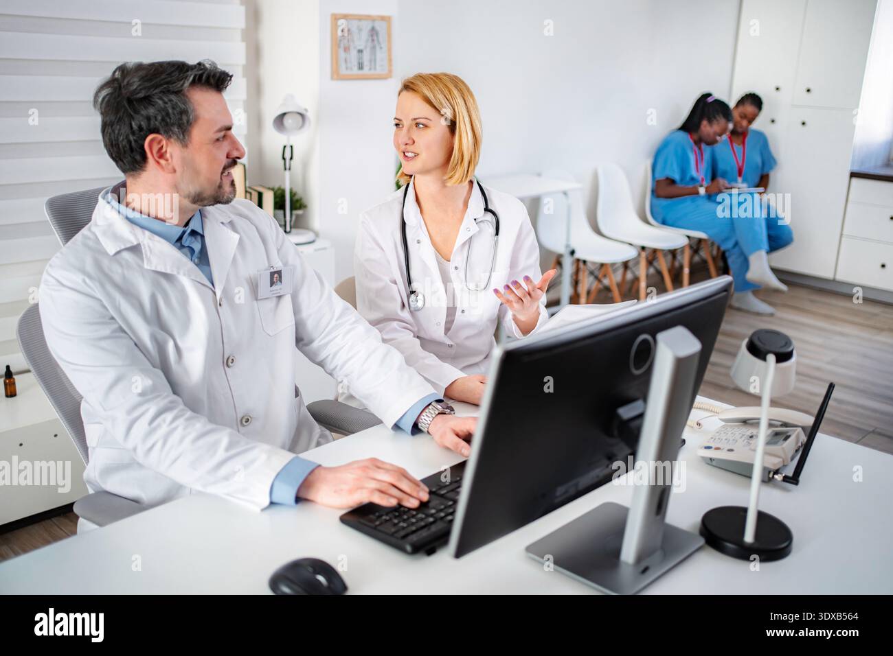 Medical team collaborating in busy clinic office Stock Photo - Alamy