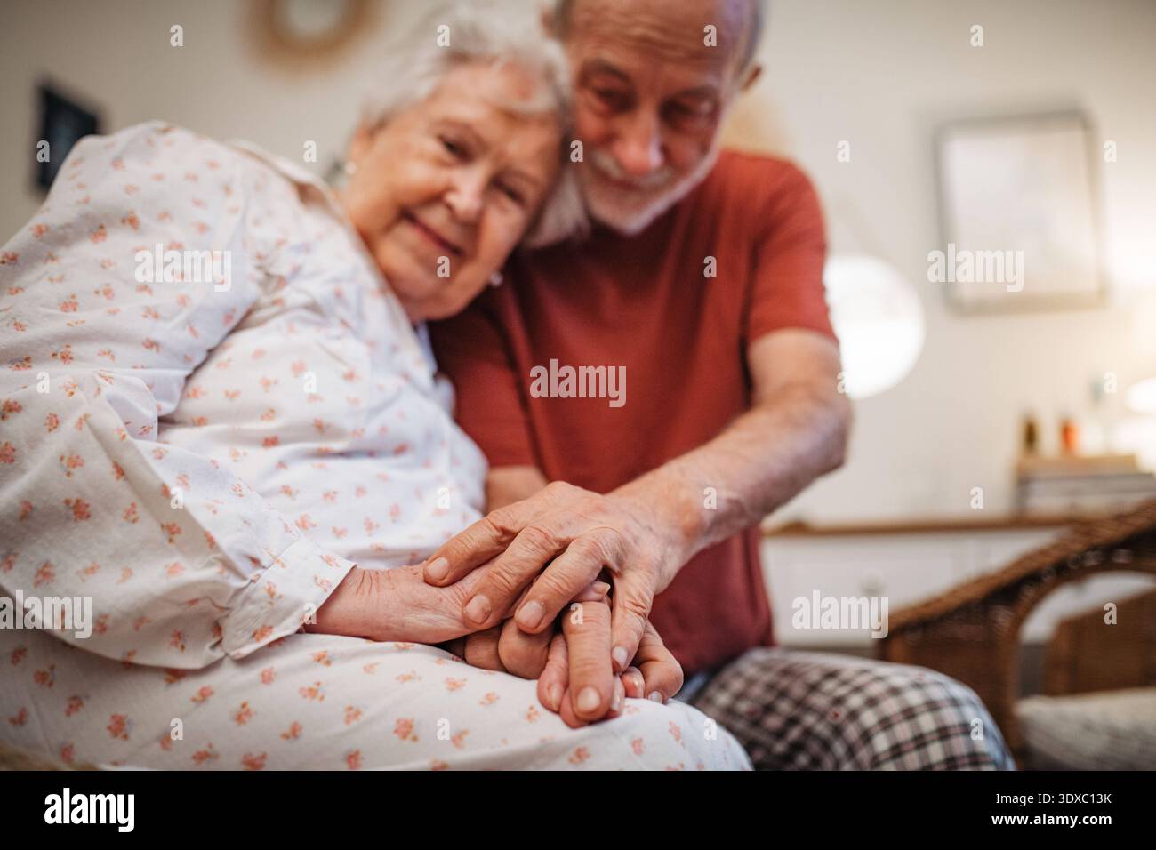 Elderly spouses sharing quiet moment before sleep. Elderly spouses sharing quiet moment before sleep. Bedtime concept. model released Stock Photo