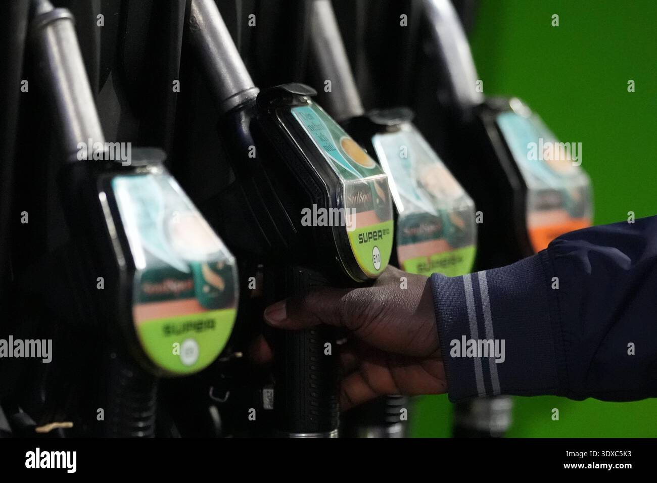 02 March 2026, Hamburg: A man fills up his car at a petrol station. Oil ...