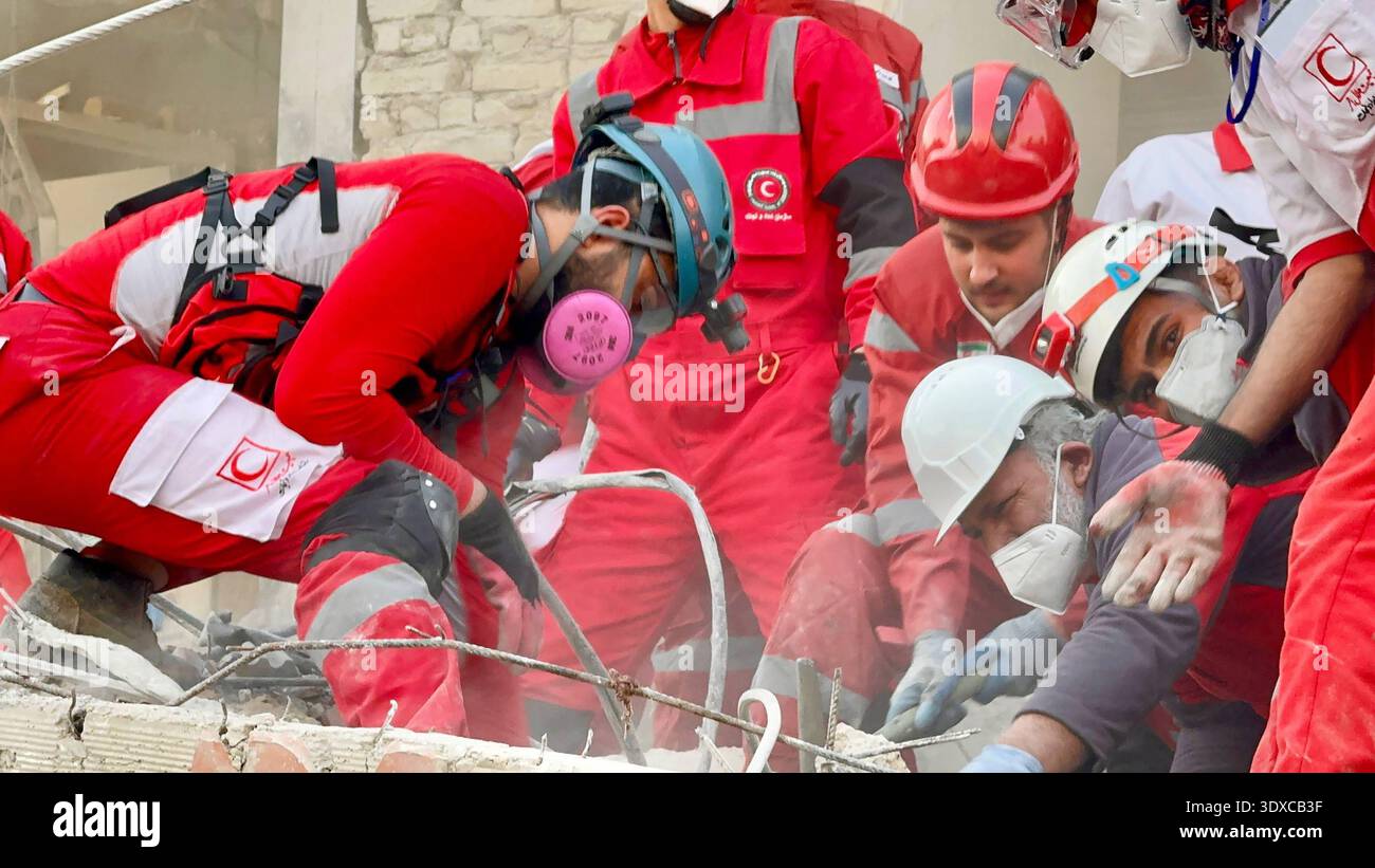 Tehran, Iran. 02nd Mar, 2026. Members of Iranian rescue teams search ...