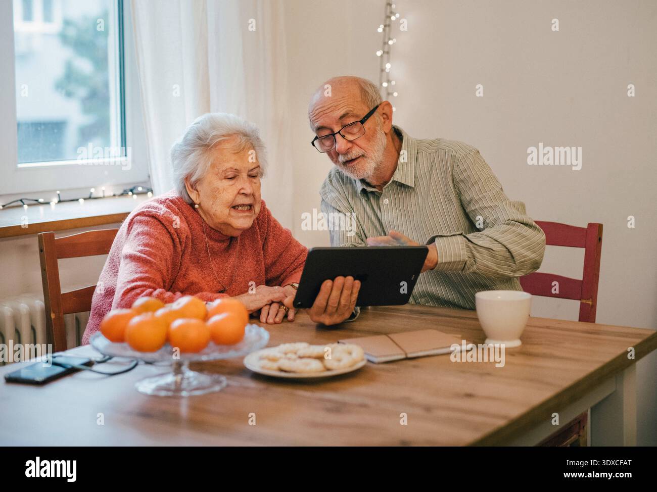 Senior coule working with tablet, having problem with technology. Senior coule working with tablet, having problem with technology. Digital literacy. Stock Photo