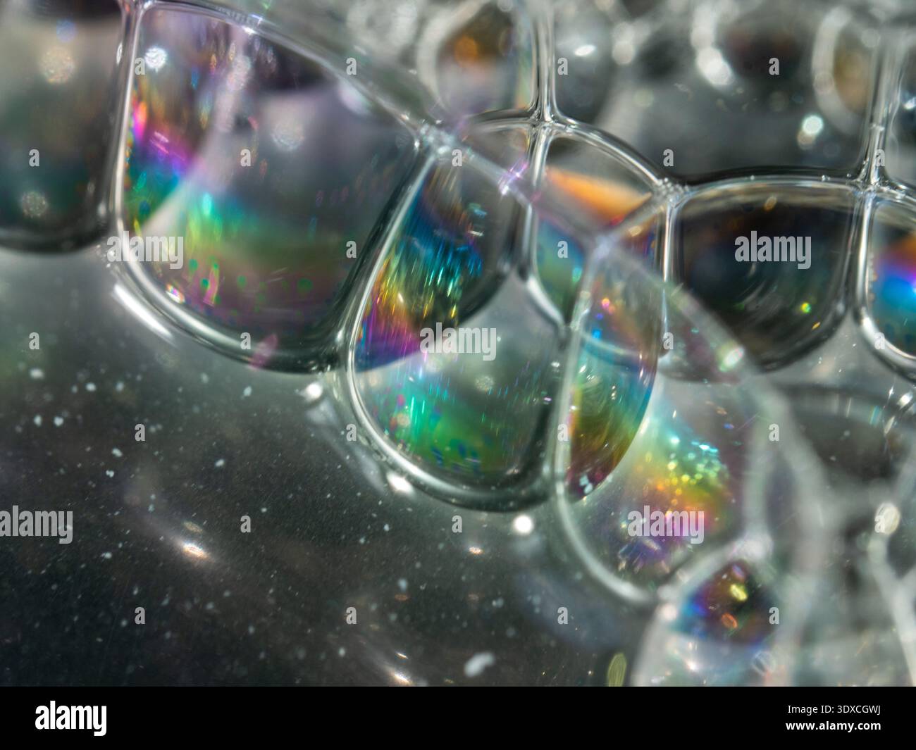 Irregular bubbles gleam with rainbow hues Stock Photo