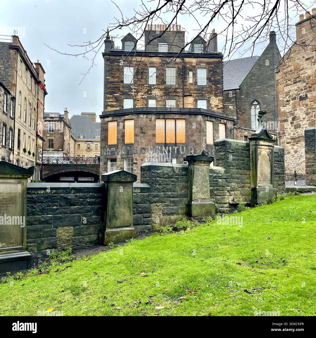 Headstones and stone memorials at Greyfriars Kirkyard cemetery in Edinburgh’s Old Town on an overcast day. - Smartphone Captured Stock Image