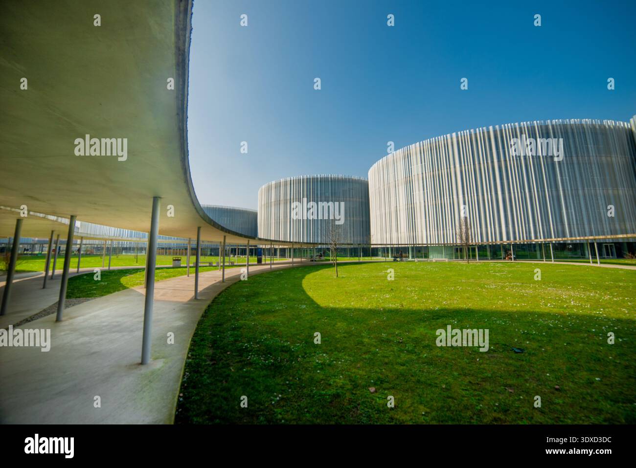 Milan Italy 27 February 2026: Bocconi University Contemporary architectural complex characterized by cylindrical buildings with metal facades and vert Stock Photo