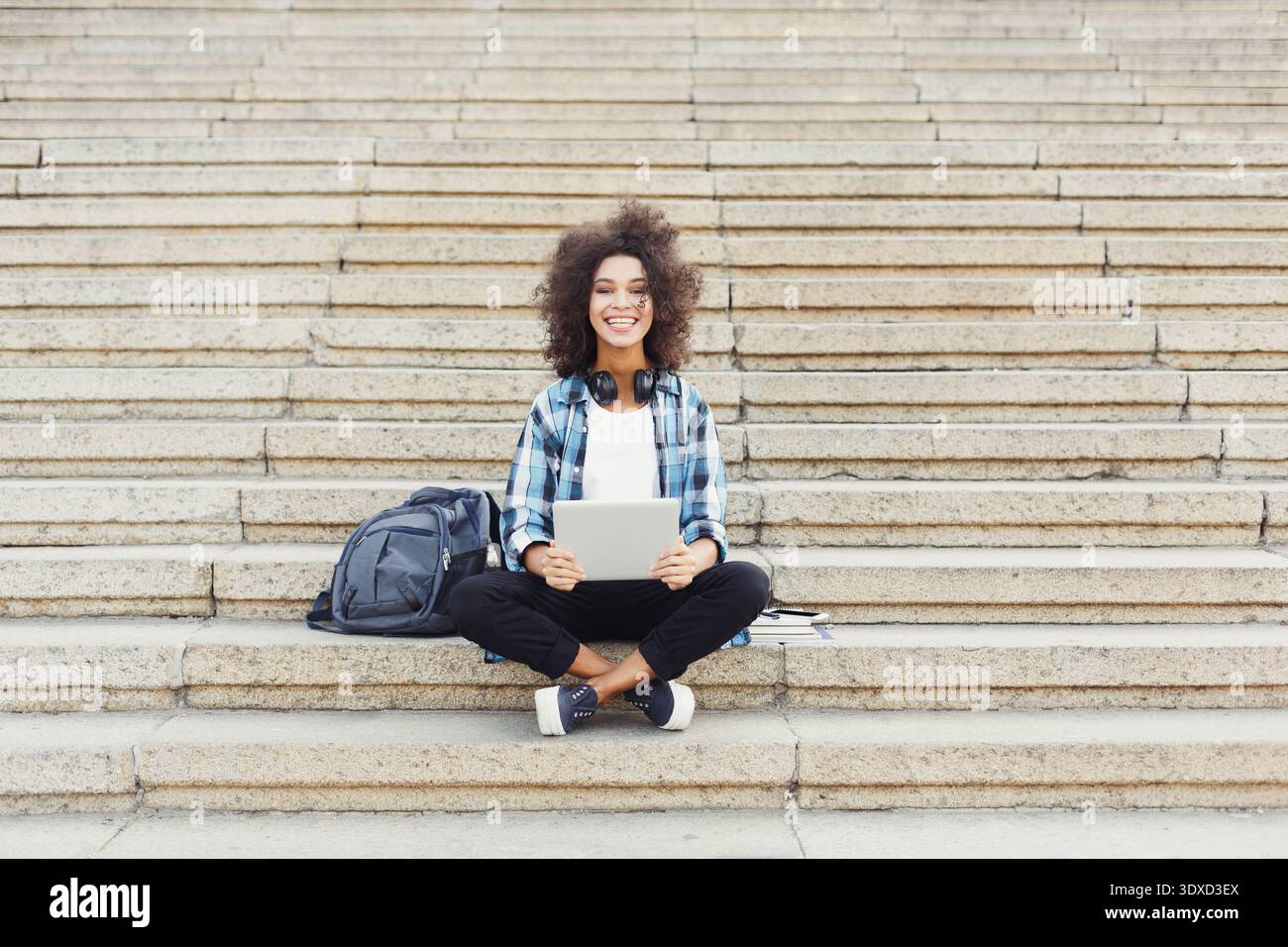 A Young Woman Sits on Steps Stock Photo