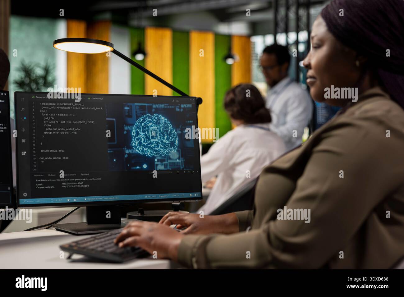 System administrator in AI tech company workplace using PC to conduct code reviews. IT specialist using computer program at office desk to design and implement machine learning algorithms Stock Photo