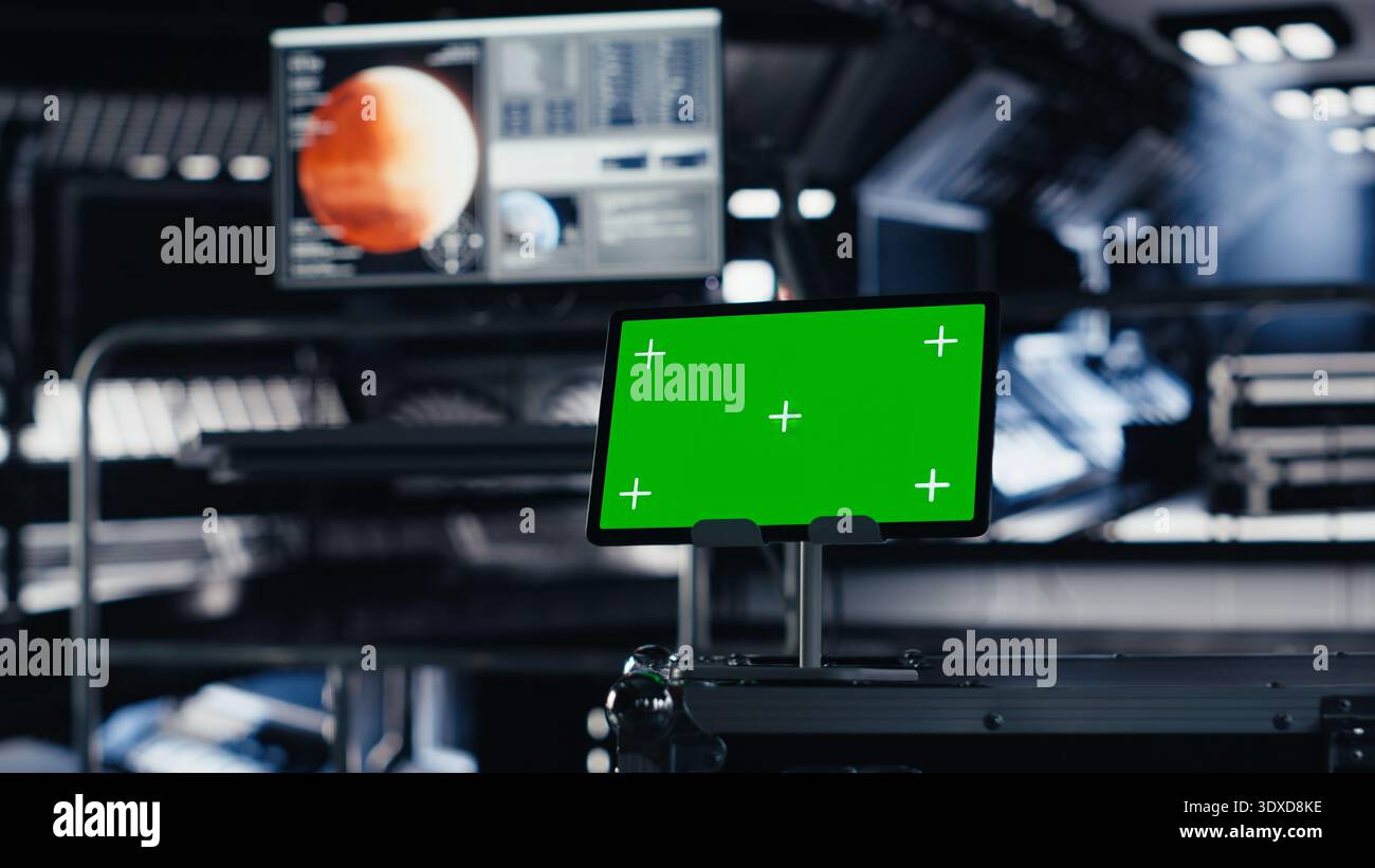 Chroma key tablet in orbital station surrounded by high tech gear ...
