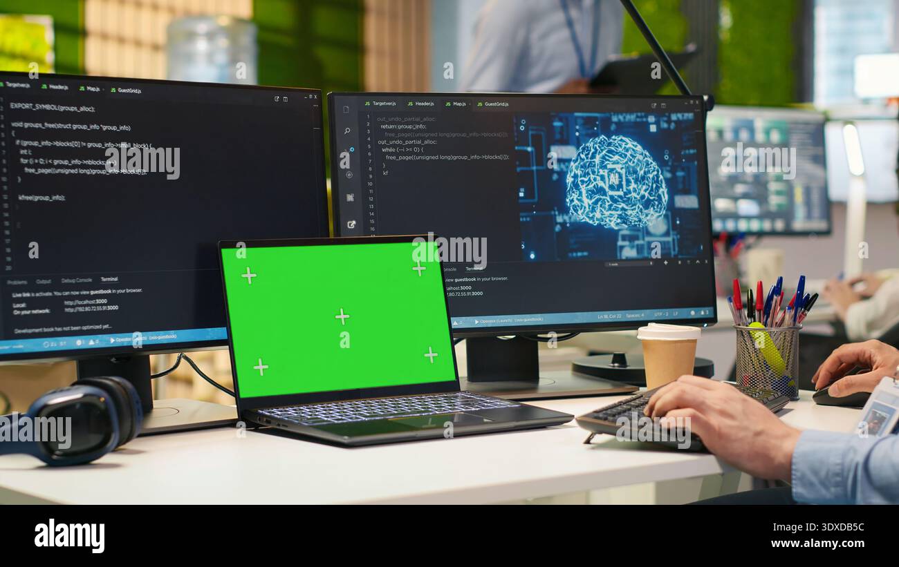 Admin in office using isolated screen laptop, automating repetitive tasks with AI scripts. IT expert using artificial intelligence on chroma key device to speed up feature implementation, camera A Stock Photo