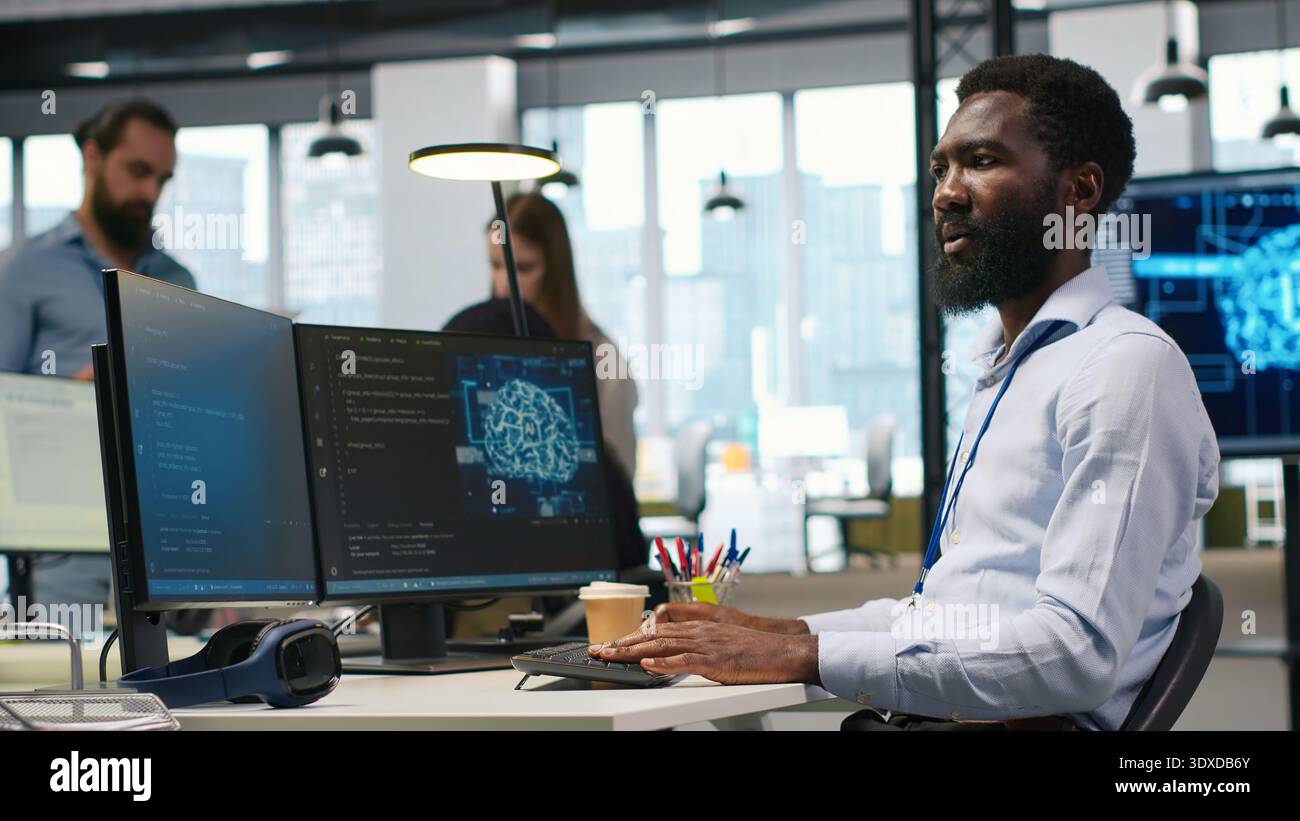 System administrator in office using PC, automating repetitive tasks with AI scripts. IT specialist using artificial intelligence technology to speed up feature implementation, camera A Stock Photo