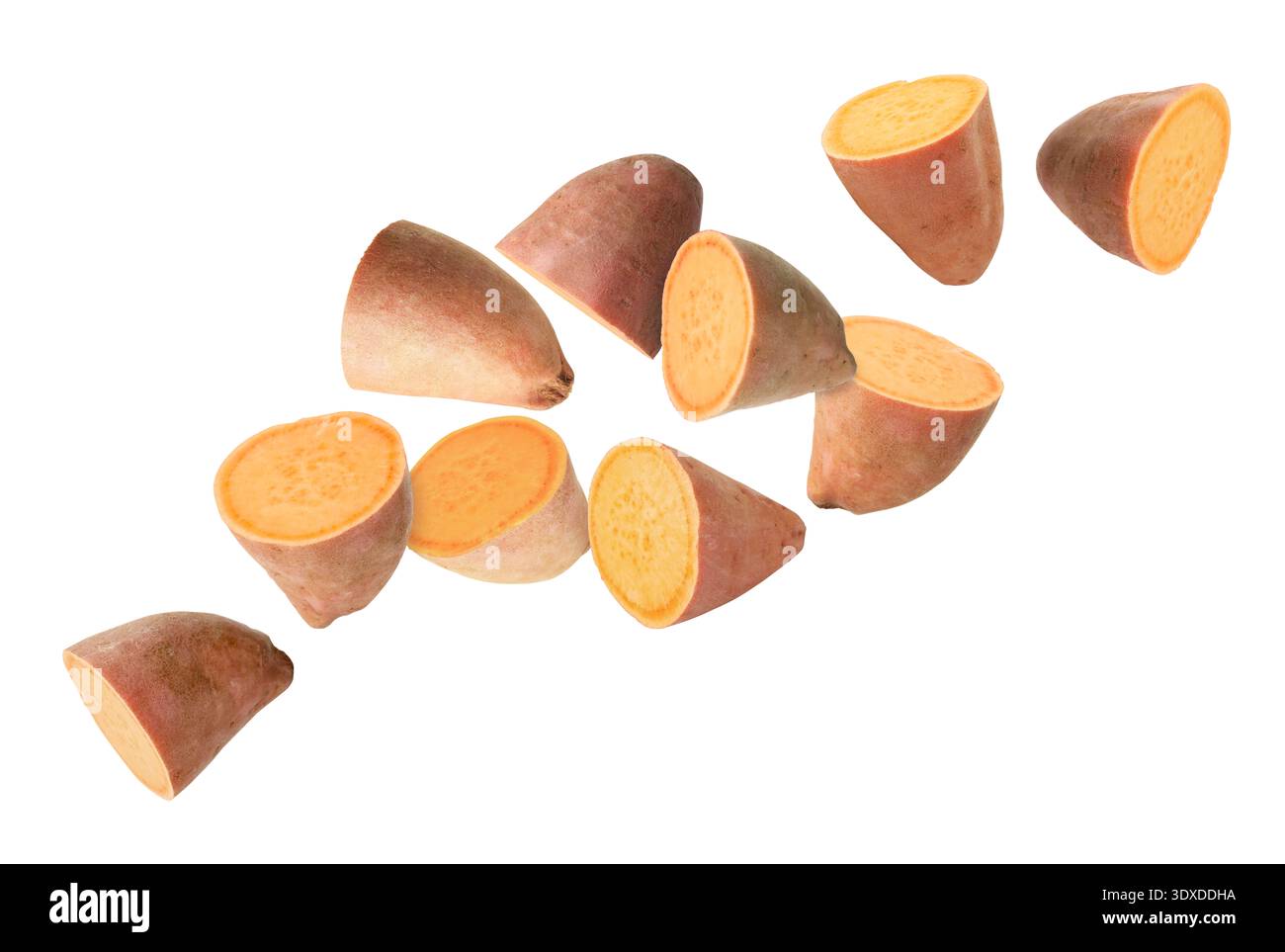 Sweet potato pieces falling against white background Stock Photo
