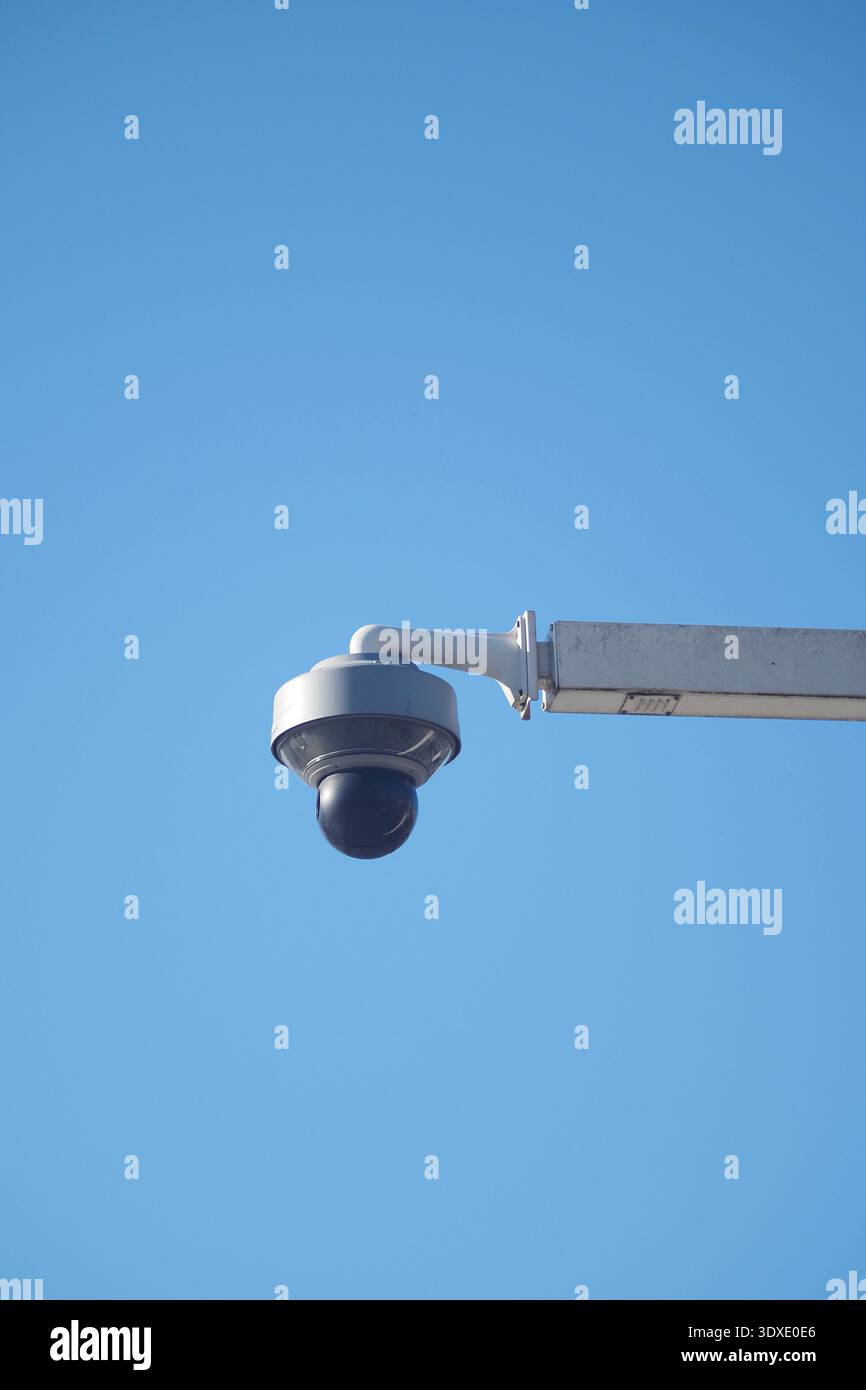 Security camera mounted on pole against clear sky Stock Photo
