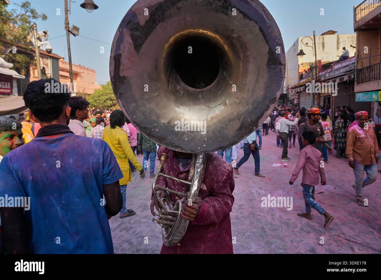 A member of a band accompanying a Holi festival procession plays a ...