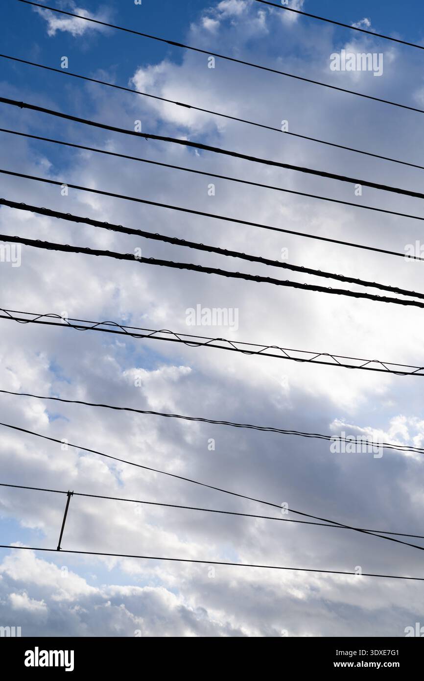 Blue Sky and White Clouds Background with Horizontal Power Lines Stock Photo