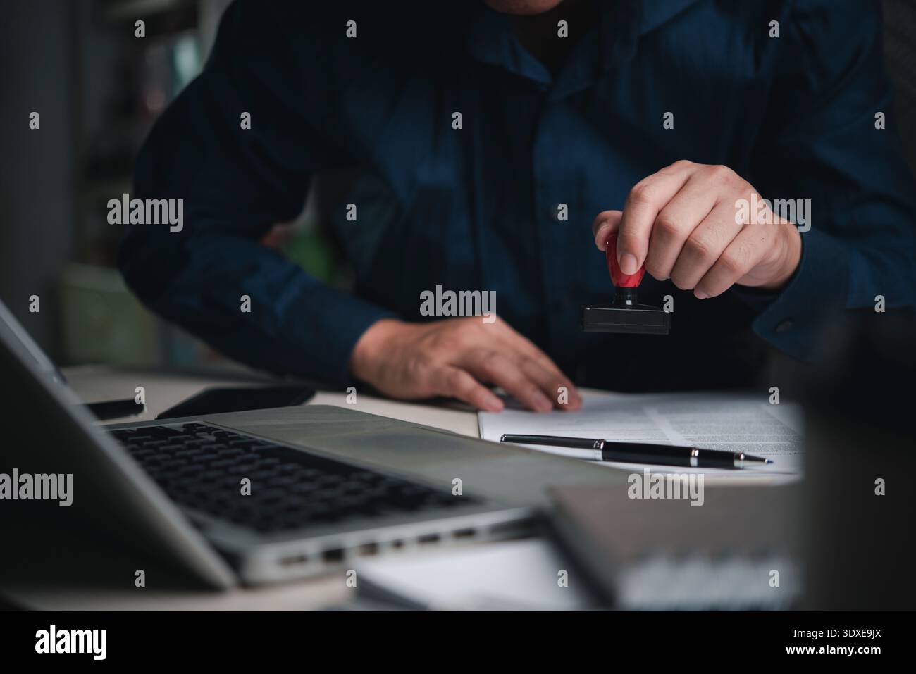 Insurance Stamping Example Man person stamping insurance policy file workplace computer ...