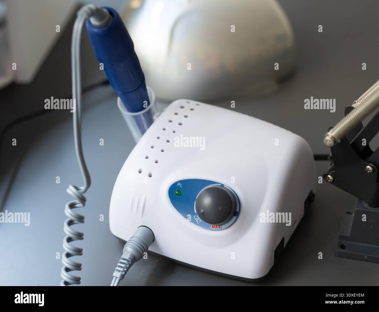 Electric manicure machine on table. Drill for manicure Stock Photo