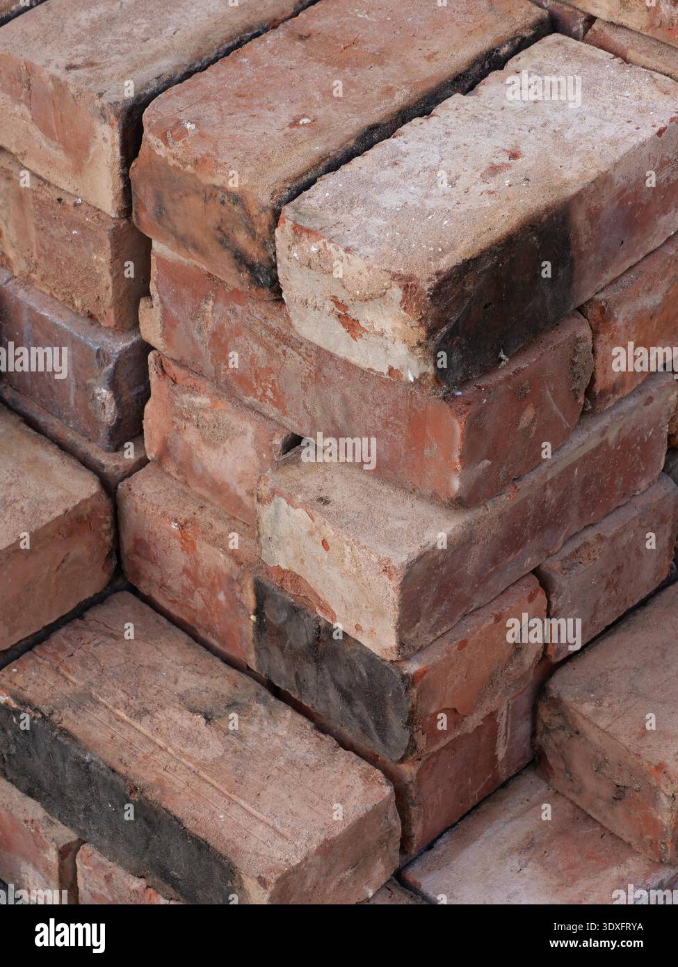 An isometric stack of various reclaimed house bricks Stock Photo