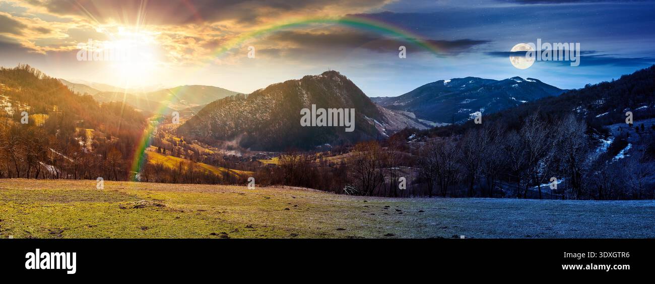 amazing panorama of a countryside landscape on spring equinox. day meet night. sun and moon over of mountainous rural area with forested hill. rolling Stock Photo