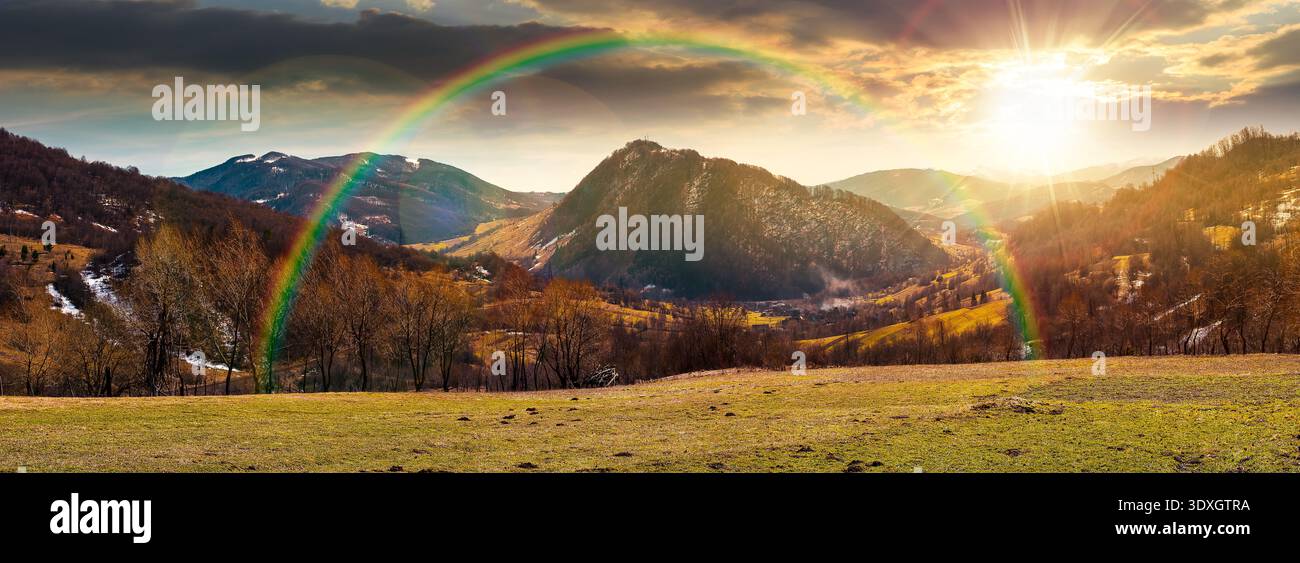 sunset over wonderful panorama of a countryside landscape in springtime. beautiful view of mountainous rural area with forested hill. rolling alpine s Stock Photo