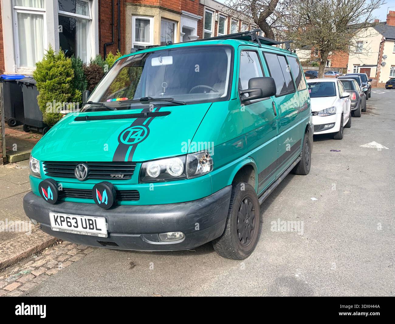 Custom painted green Volkswagen van parked on a suburban street in Northampton Northamptonshire England UK German vehicle bright green with design - Smartphone Captured Stock Image