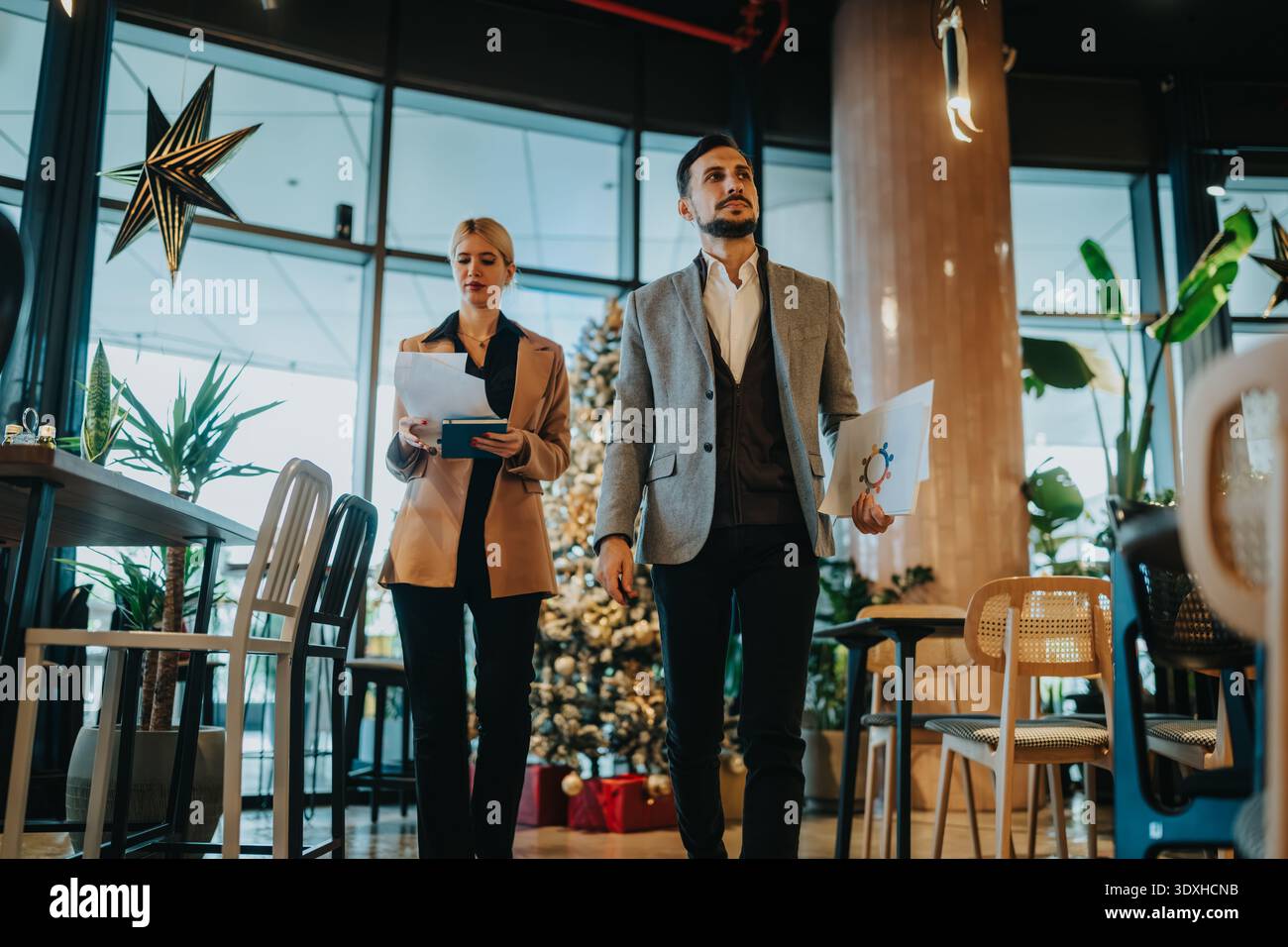 Business partners review documents in a modern office during the holidays season Stock Photo