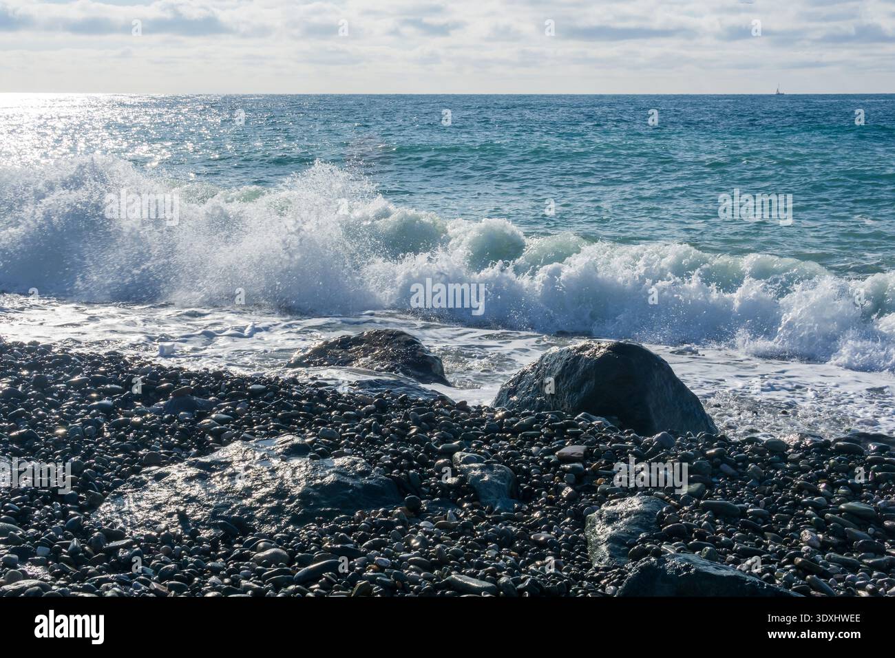 Beautiful seascape with waves breaking on the rocky shore. Stock Photo