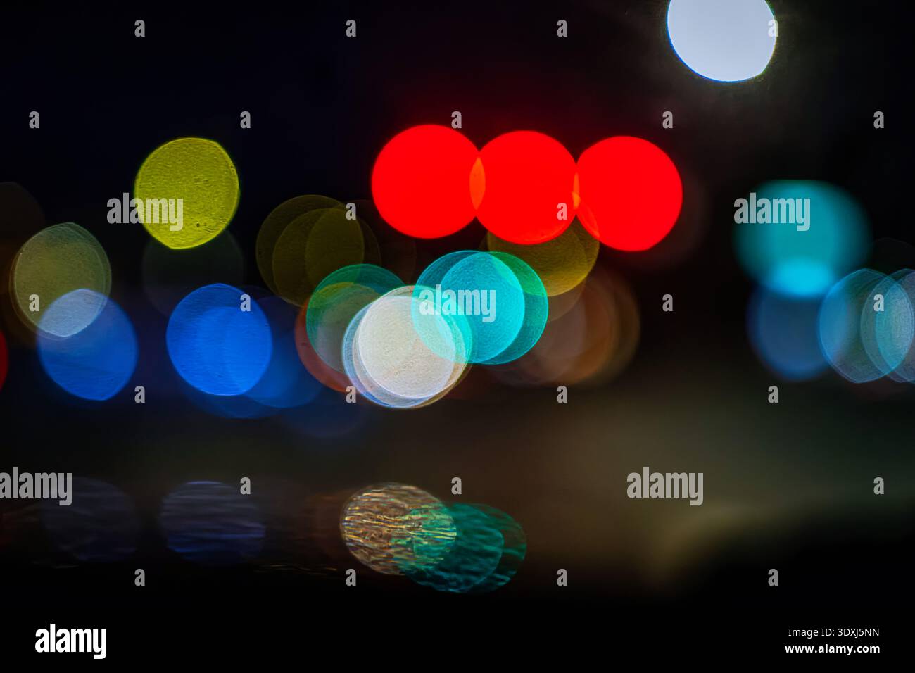 Abstract colorful bokeh lights at night with soft focus and vibrant circles creating a dreamy urban background Stock Photo