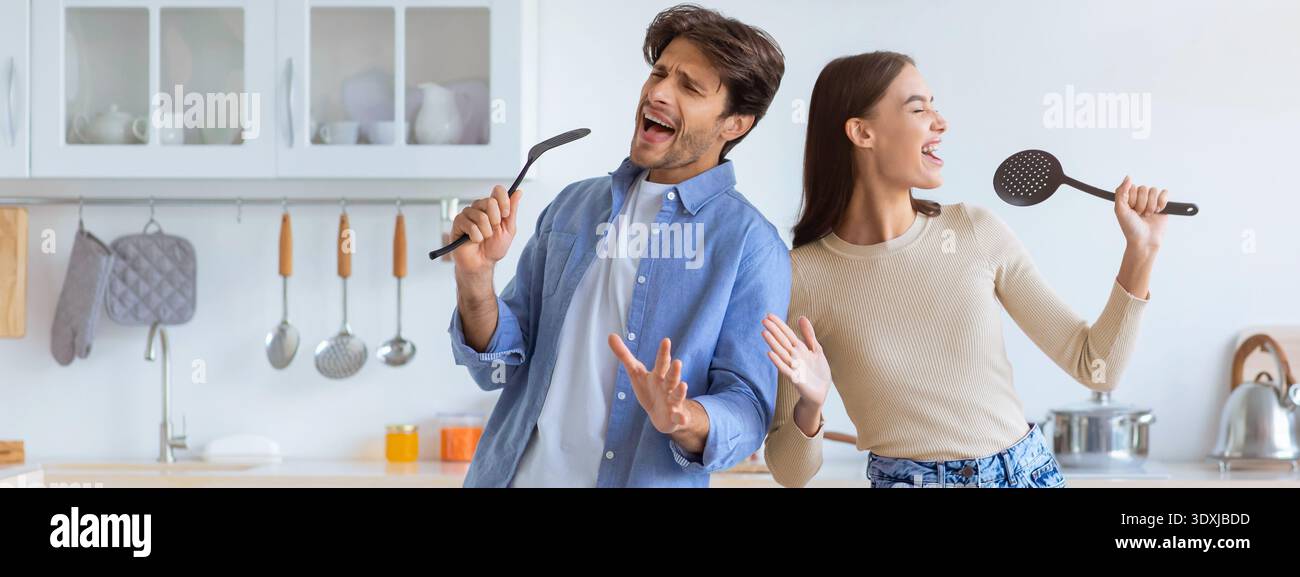Couple Having Fun While Singing in the Kitchen During the Day Stock Photo
