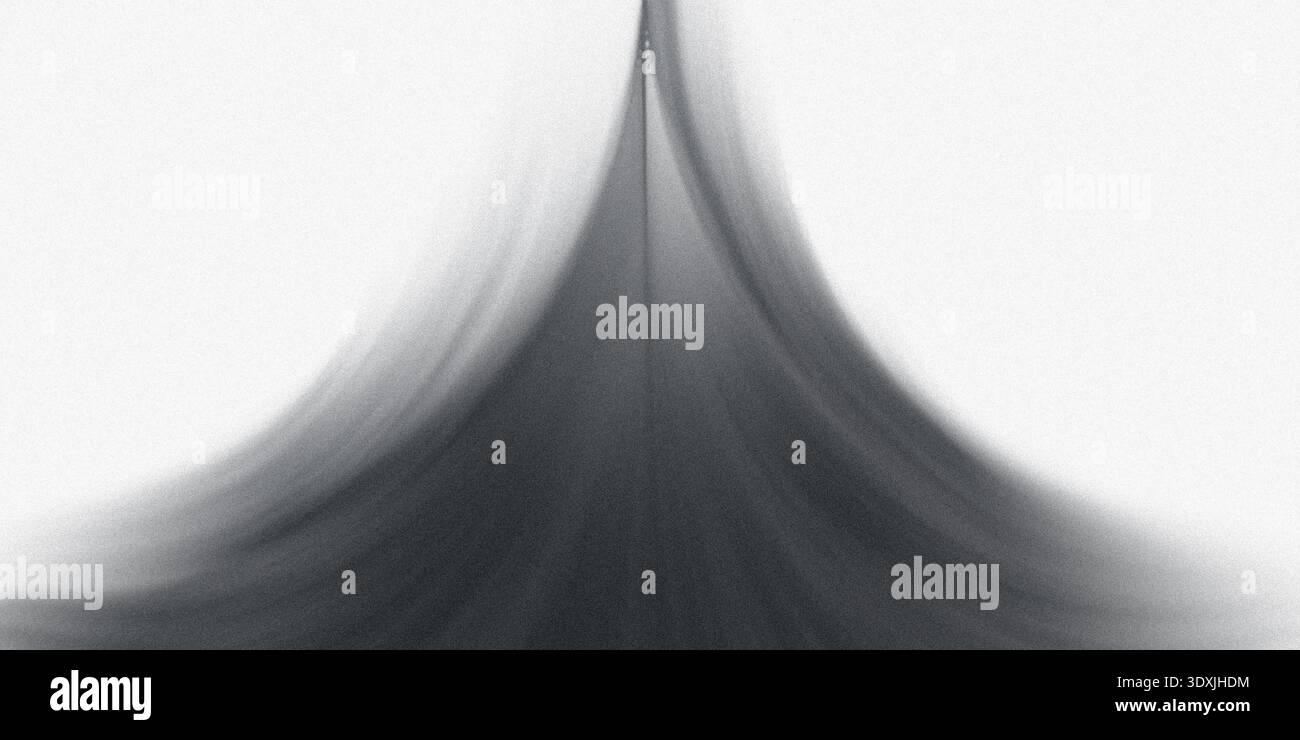 A grayscale abstract image featuring a blurred and distorted shape against a white background creating contrast Stock Photo