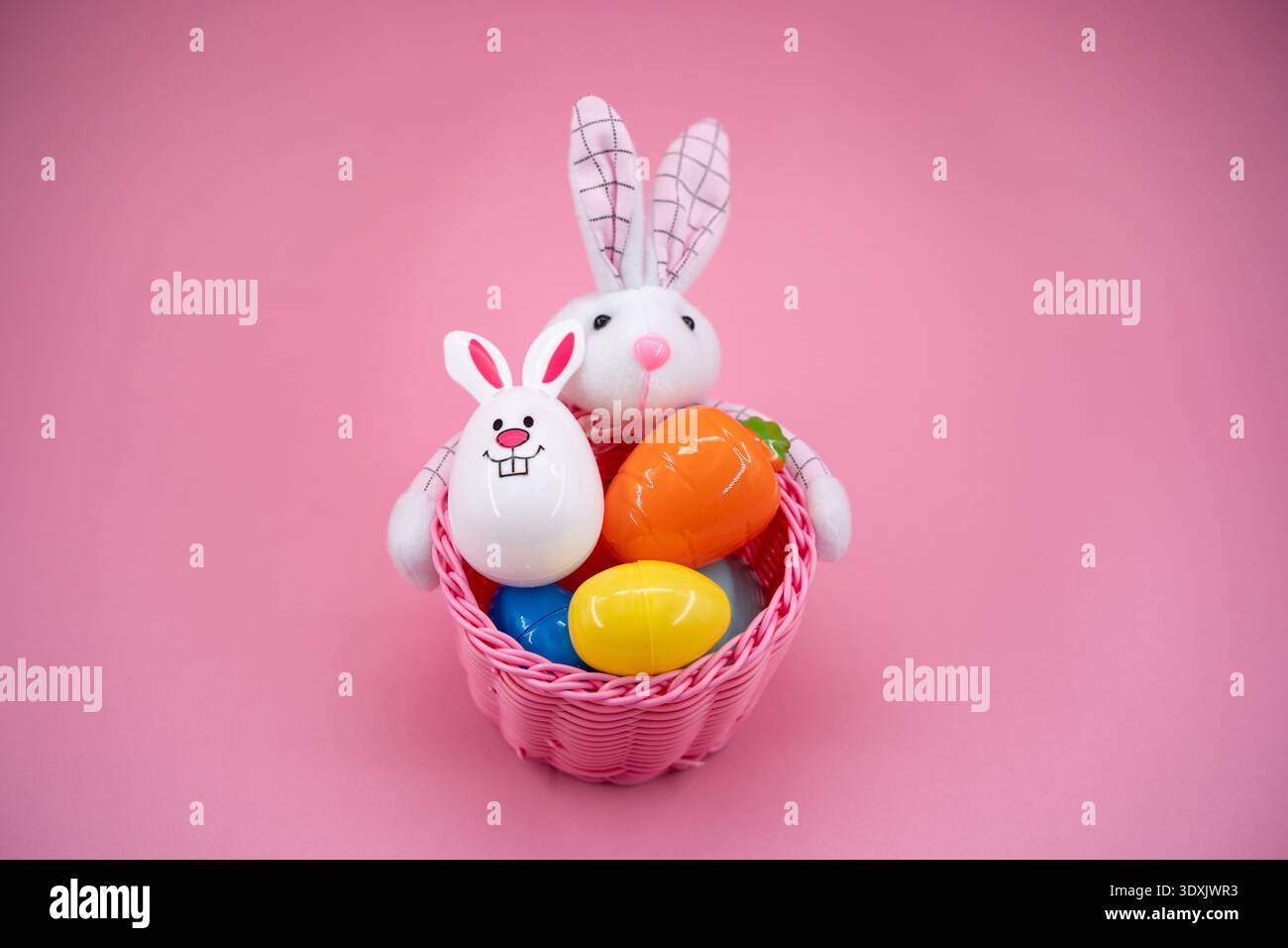 Front view of Easter basket with bunny and colorful eggs. Stock Photo