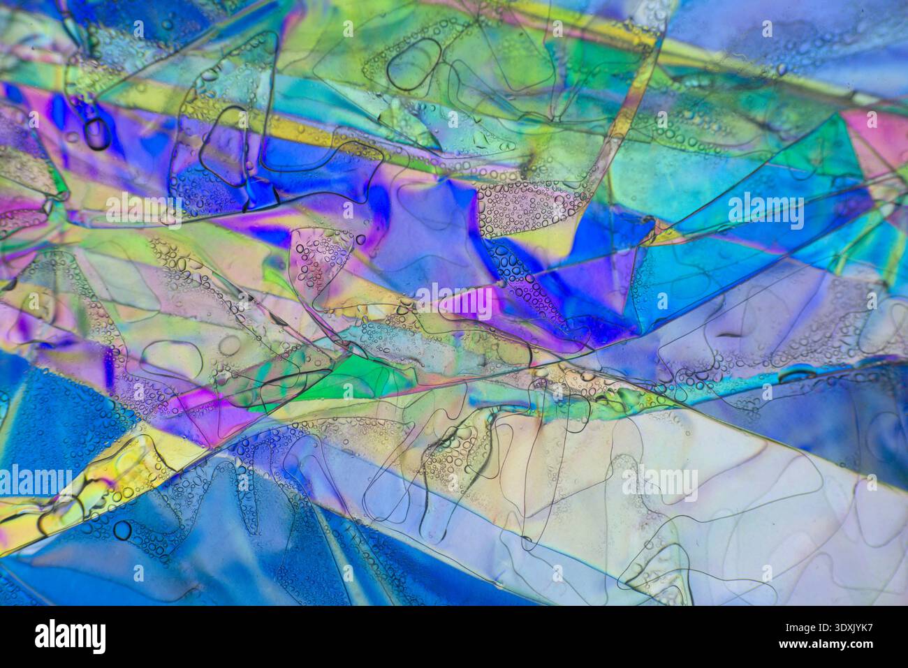 Complex geometric planes and iridescent colors in a microscopy interference pattern. Stock Photo