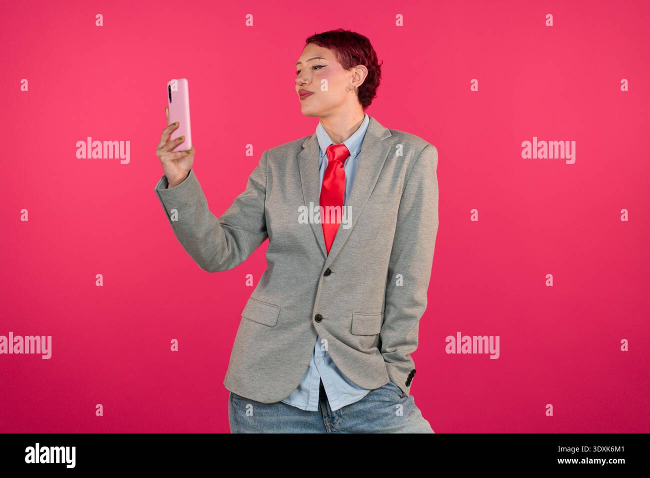 Person taking selfie with smartphone on pink background Stock Photo