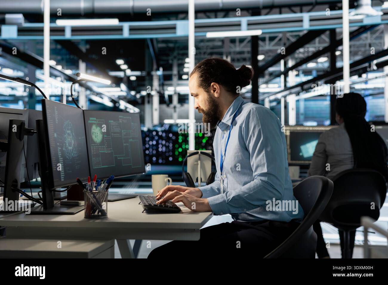 Data center worker using artificial intelligence neural networks technology on PC. Server farm facility software developer using AI programming language on computer to update hardware Stock Photo
