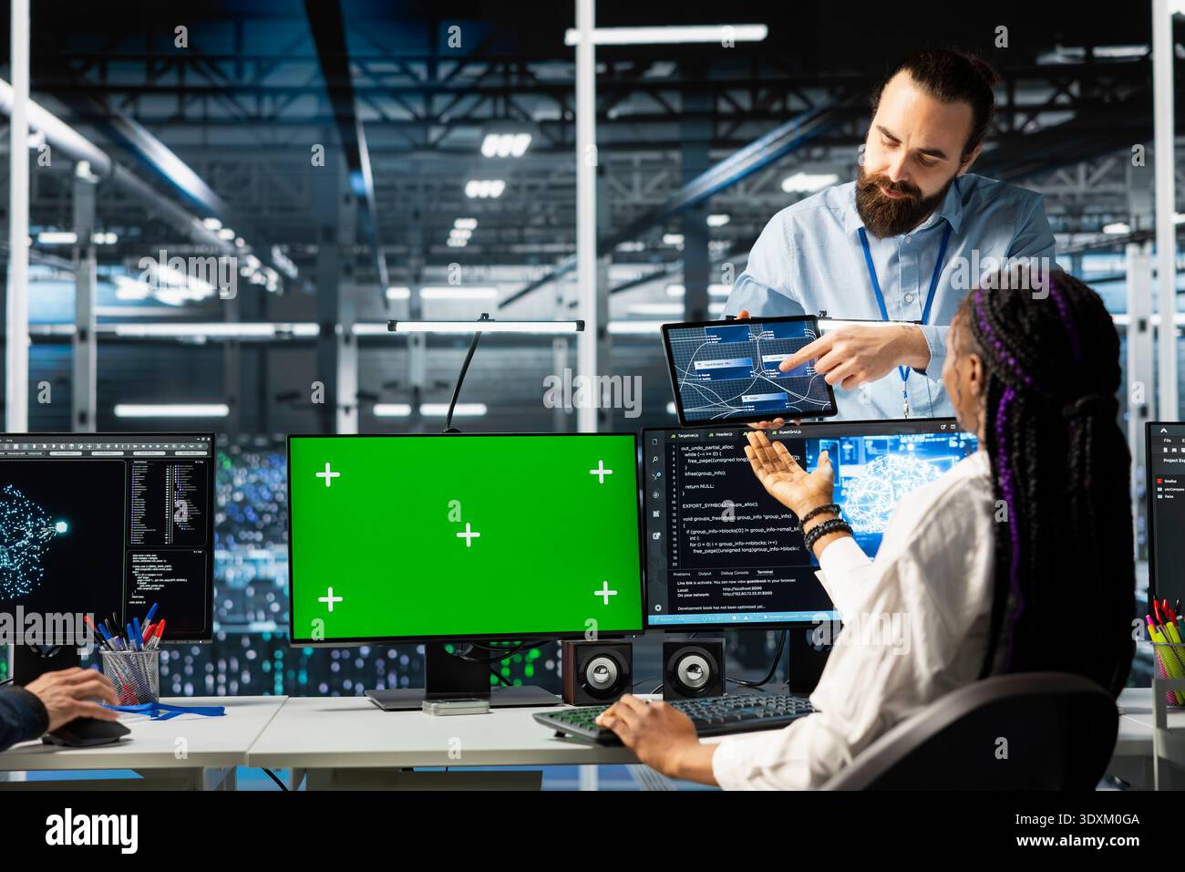 Coworkers coding in data center using green screen mockup PC, updating AI automation scripts. Server room colleagues using chroma key mockup computer, programming artificial intelligence algorithms Stock Photo