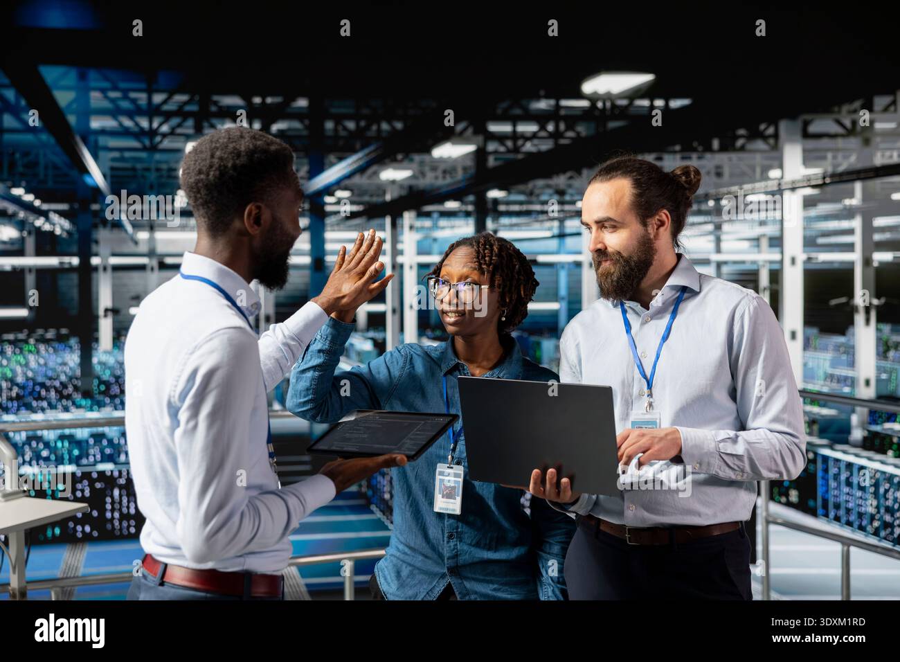 Team leader and workers celebrating IT progress with high five, enjoying software management achievement and cheering for success. Confident engineering team clapping hands on industrial platform. Stock Photo