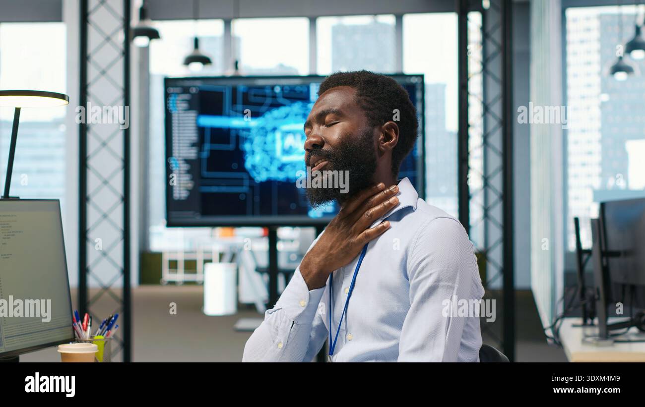 System administrator in tech startup office using PC, troubleshooting hardware and software issues. IT professional at work monitoring and optimizing performance using computer, camera A Stock Photo
