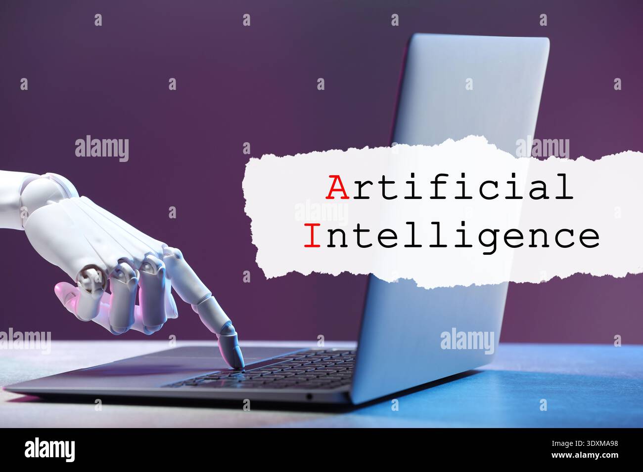 Robot using laptop. Text Artificial Intelligence on torn paper Stock Photo