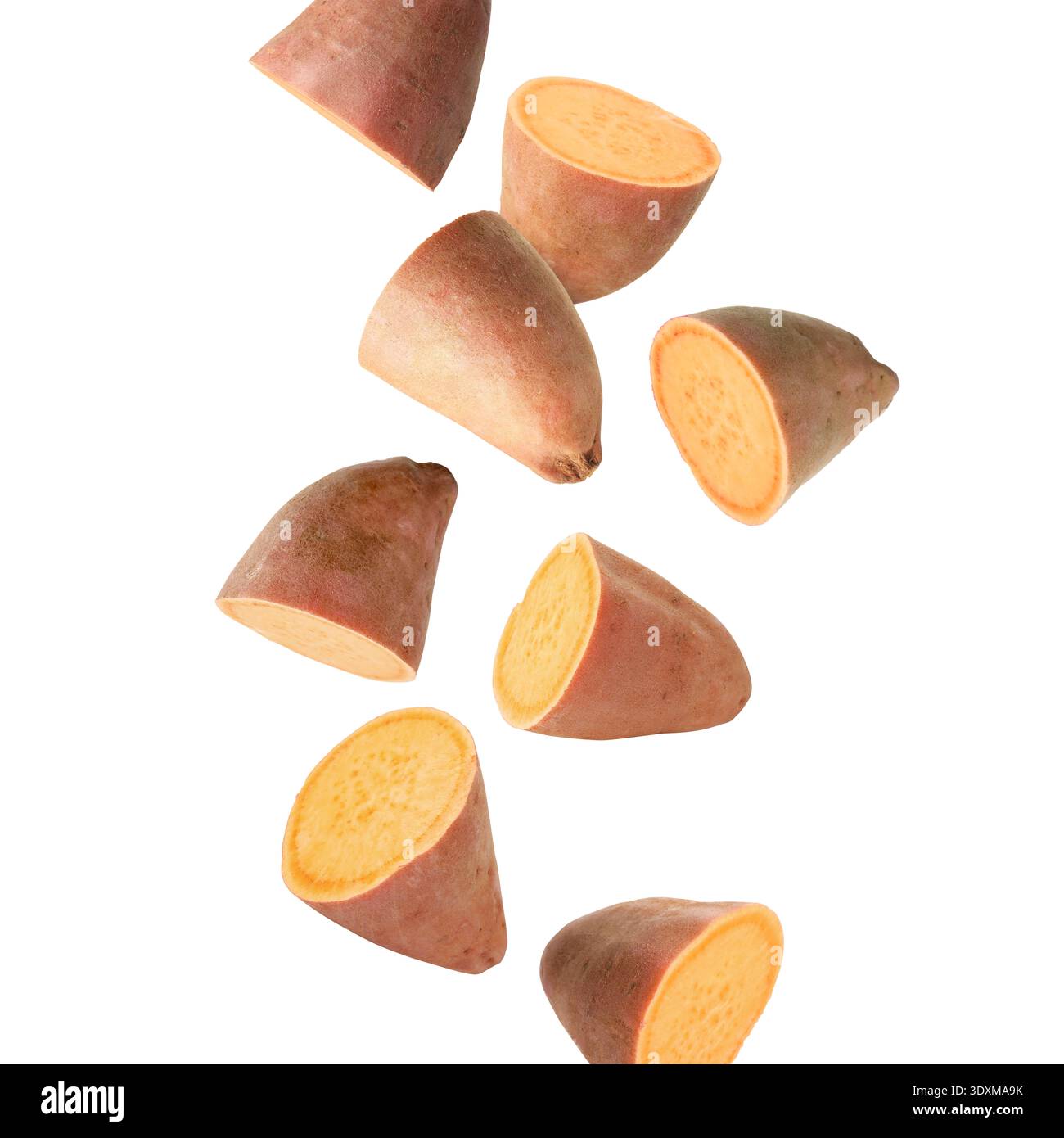 Sweet potato pieces falling against white background Stock Photo