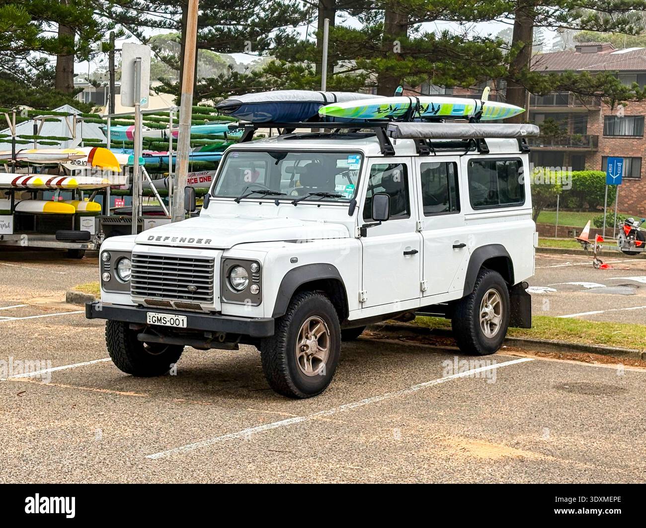 2015 model Land Rover Defender 4WD parked in Sydney, Australia carrying surfboards on the roof - Smartphone Captured Stock Image