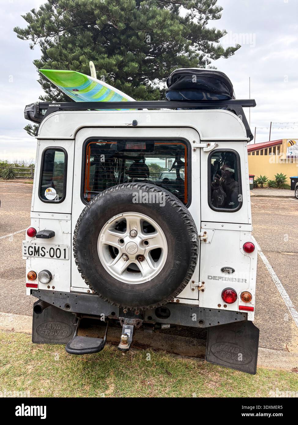 2015 model Land Rover Defender 4WD parked in Sydney, Australia carrying surfboards on the roof - Smartphone Captured Stock Image