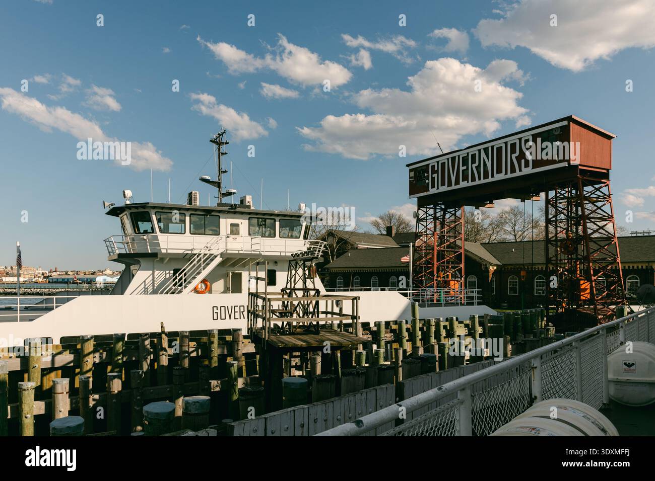 A ferry is docked at Governors Island ready to transport passengers ...