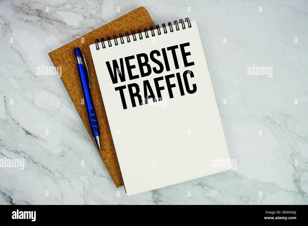 Website Traffic text written on notepad with pen on marble background Stock Photo