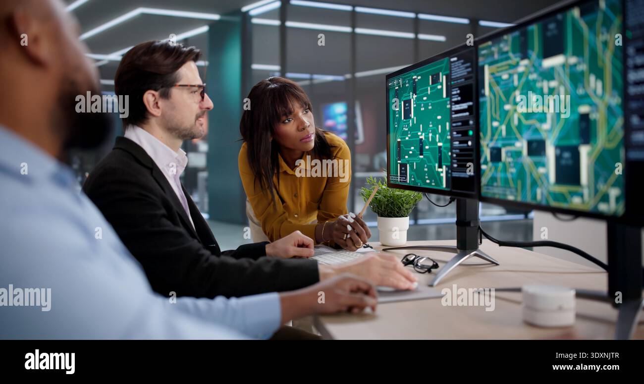 Diverse Team Collaborating On PCB Design, Developing New Technology Solutions Stock Photo